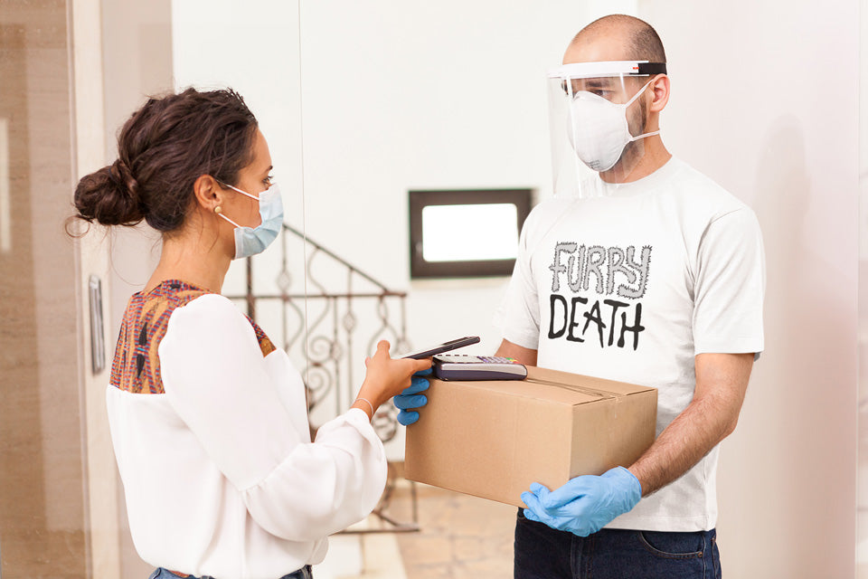 A person delivering a package wearing a face mask and gloves, with another person receiving it.